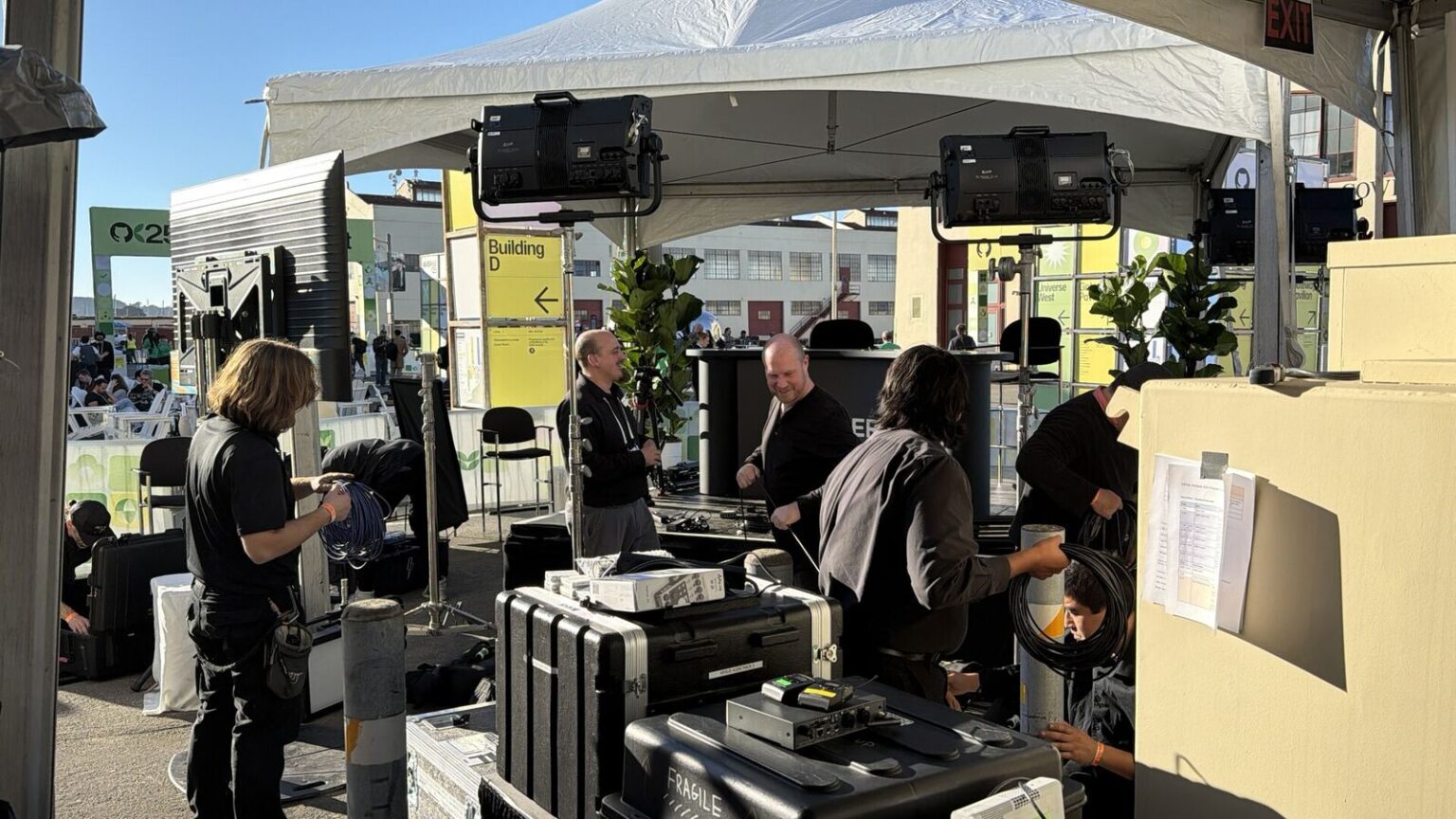 Argus HD crew rigging the TBPN podcast stage tent at GitHub Universe, Fort Mason, San Francisco